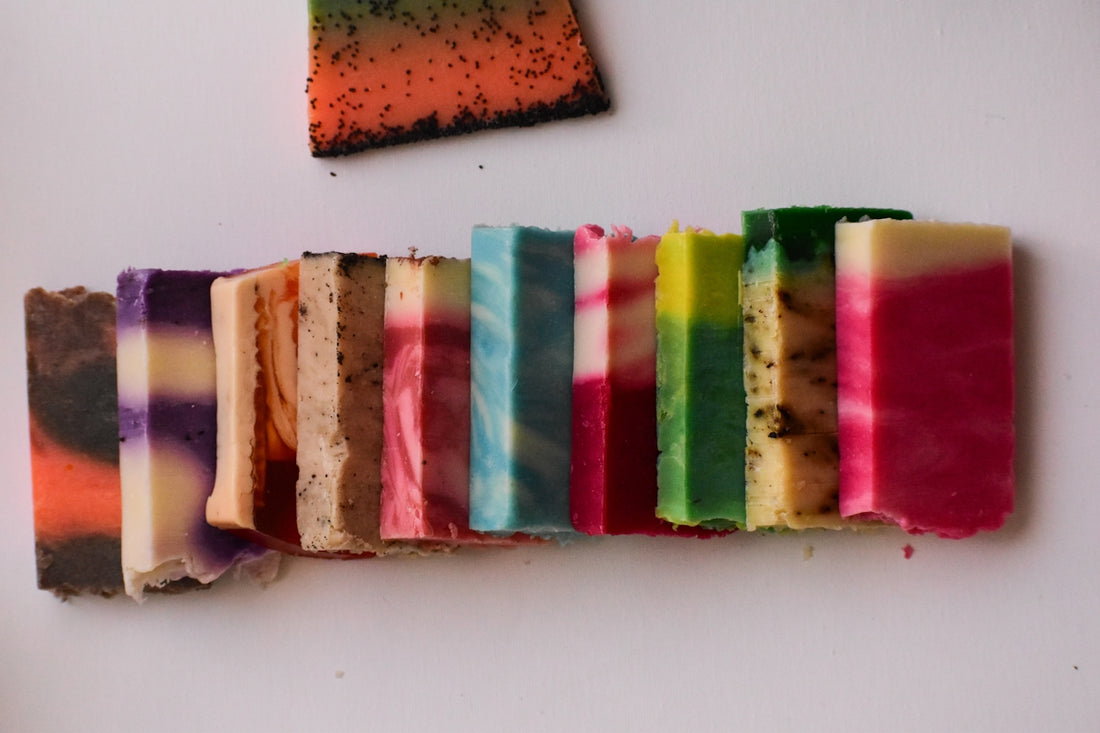 a group of different colored bars of soap on a white surface